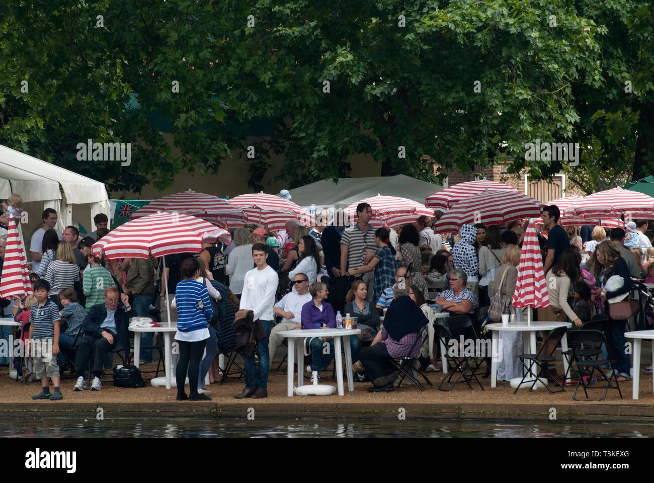 Barnes, SW London annual summer fair. They are sitting at the edge of the village pond. HOMER SYKES Stock Photo