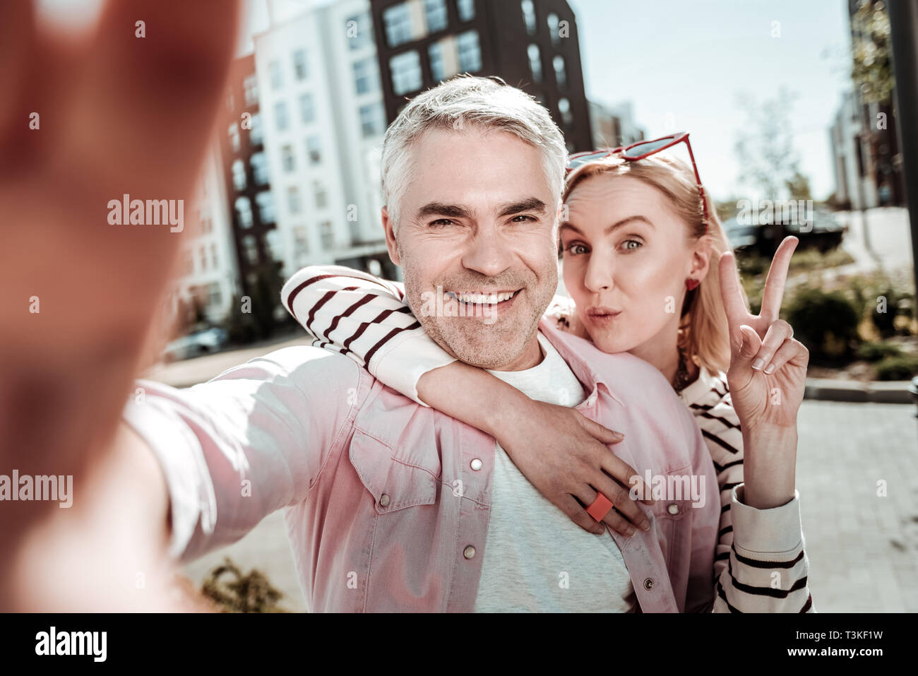 Joyful happy man taking a selfie with his wife Stock Photo