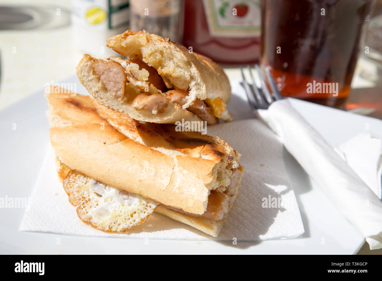 Breakfast snack of fried egg and sausage baguette served in a Tapas bar/cafe in Fuengirola, Spain. Stock Photo