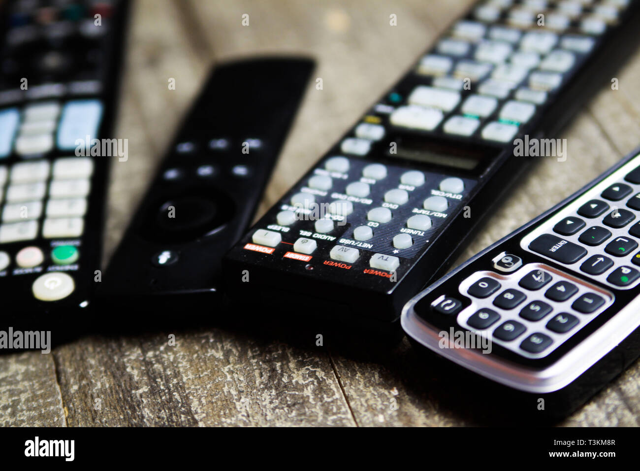 Close up of remote controls for TV, Video and stereo music system on