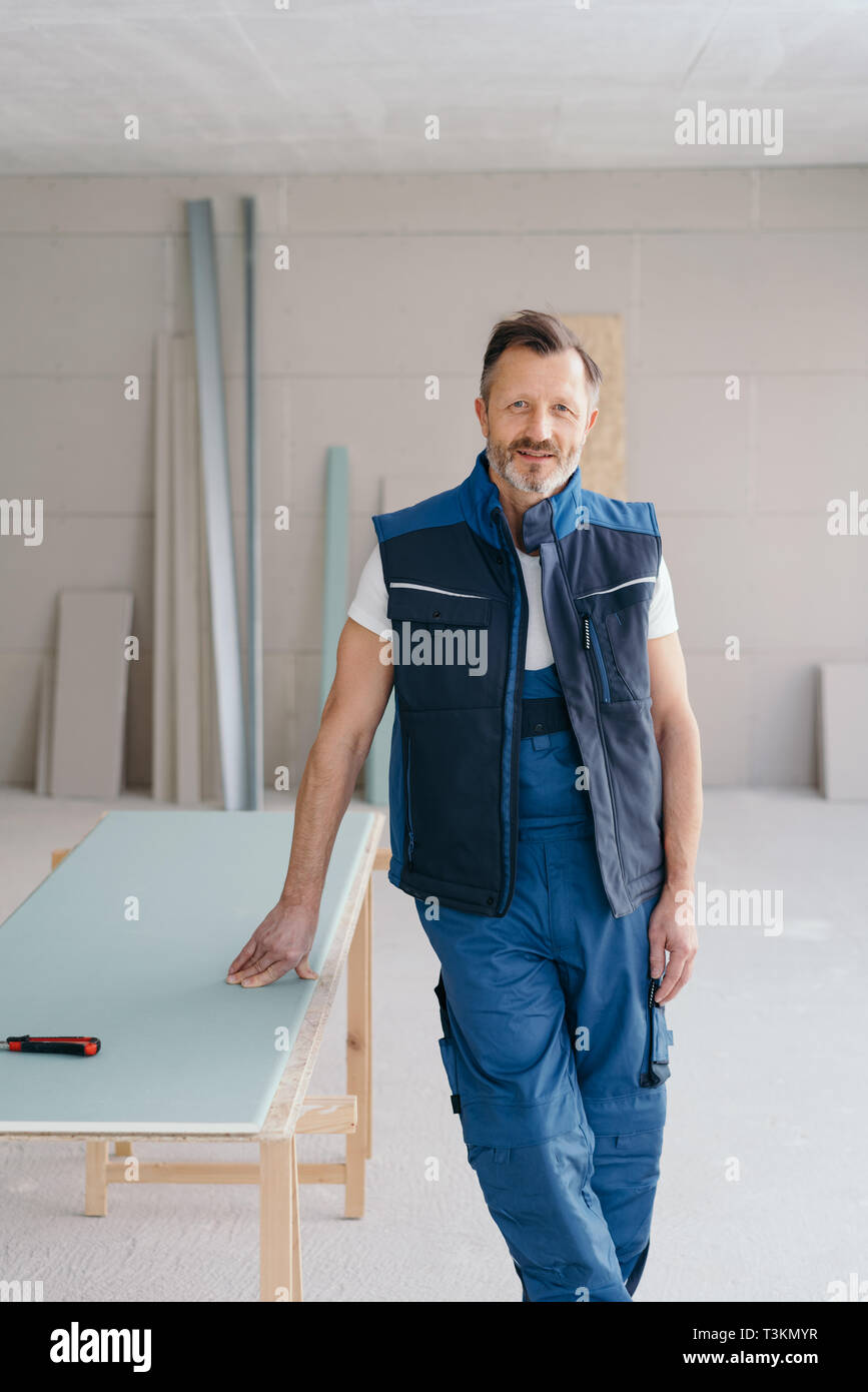 Relaxed handyman in denim dungarees 