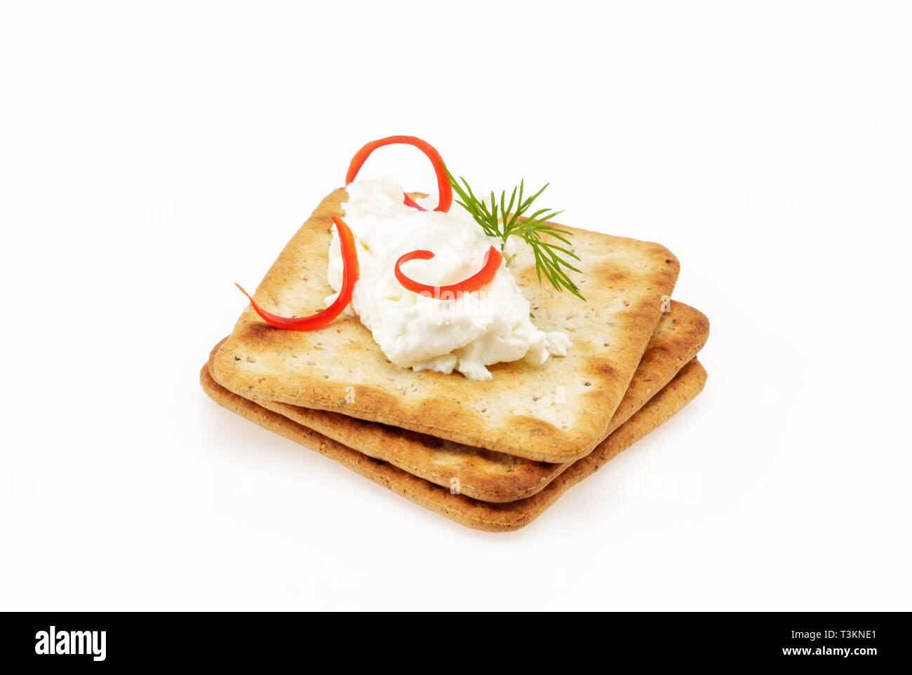 Lactose Free Cheese Spread on Crackers garnished with bell pepper Stock Photo