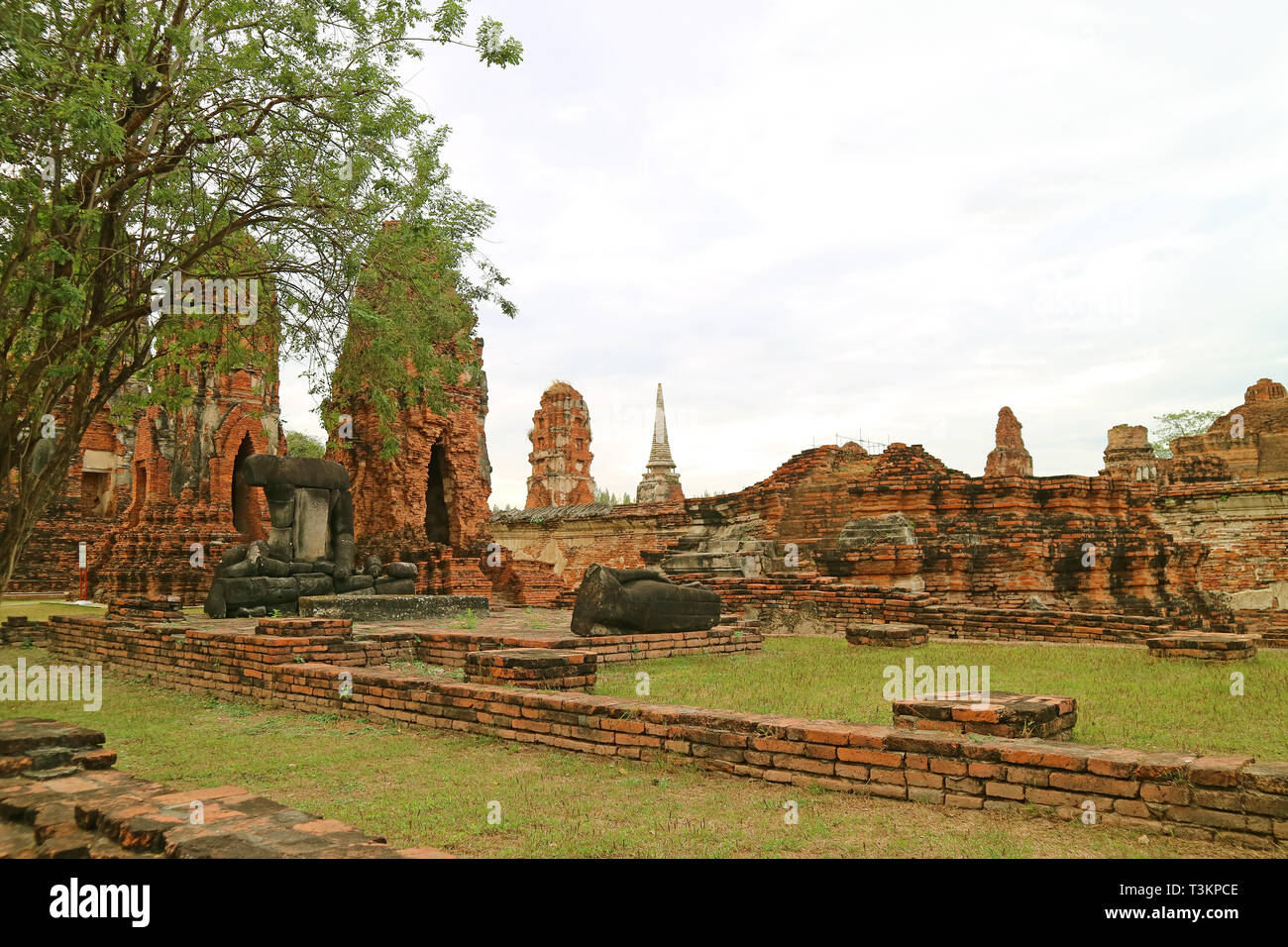 Incredible Remains of Sitting and Reclining Buddha Images at Wat Mahathat Temple, Ayutthaya Historical Park, Thailand Stock Photo