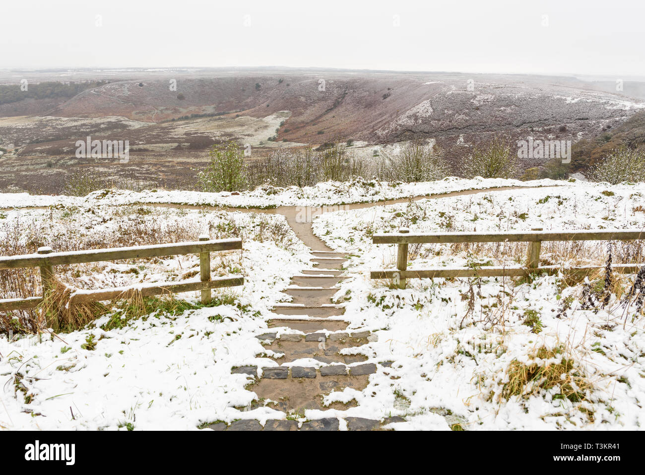 A snowy view looking down a set of steps to the Hole of Horcum Stock Photo