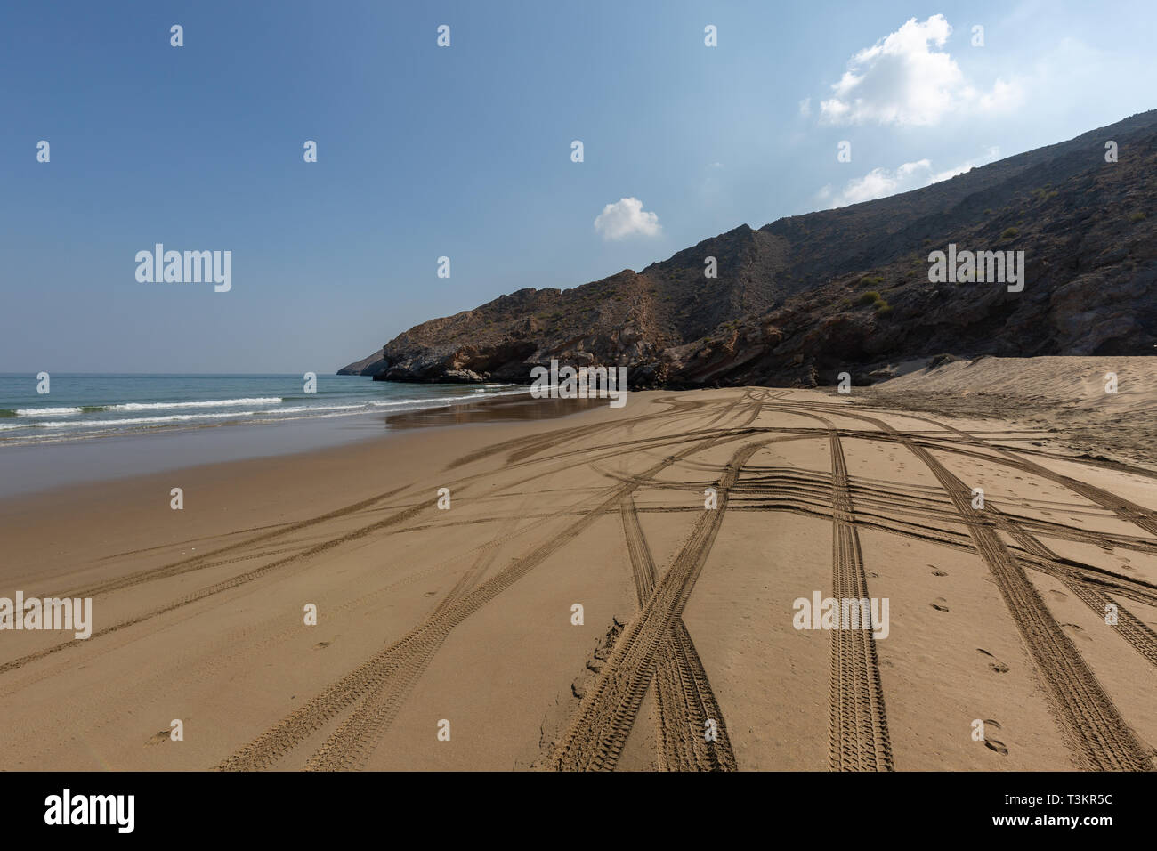 Empty Yiti Beach in the morning, tire tracks on the sand near Muscat - Sultanate of Oman Stock Photo