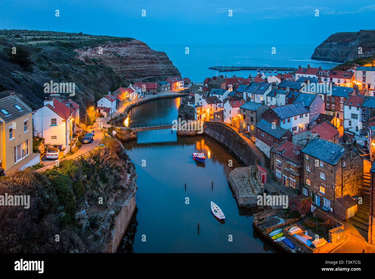 A classic view of Staithes at dusk & high tide, Staithes is a a traditional fishing village / seaside resort on the North Yorkshire coast, England UK. Stock Photo