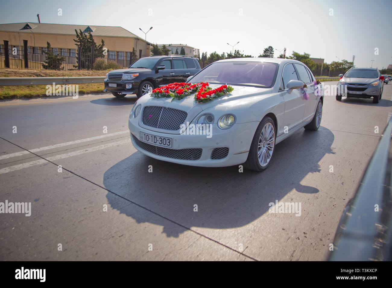 Closeup image of wedding car decoration with red and white flowers