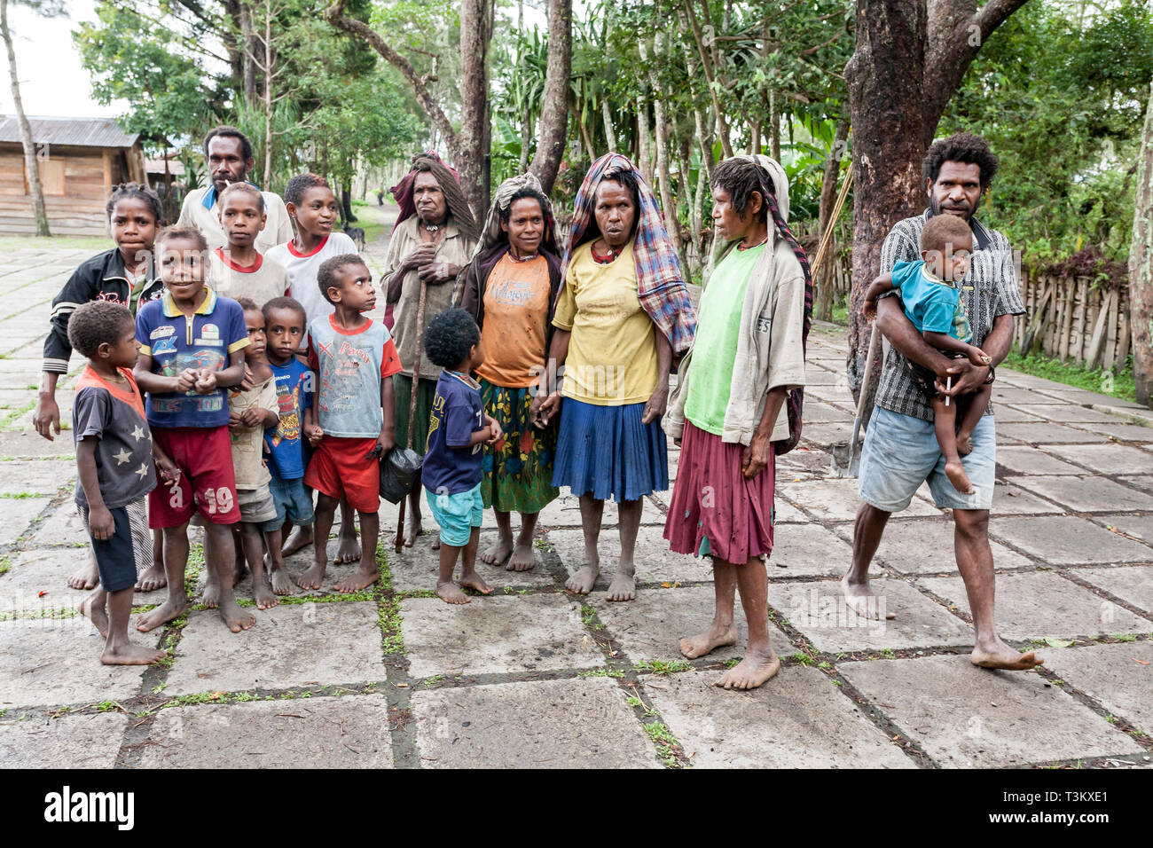 Wamena, Indonesia - January 9, 2010: People of the Dani tribe in a usual dress standing in Dugum Dani Village. Baliem Valley Papua, Irian Jaya. Stock Photo