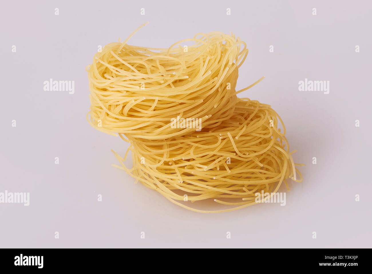 Capelli d'angelo, Angel's hair - pasta.  Homemade pasta. Italian Cuisine. Egg noodles. Italian pasta tagliatelle nest isolated Stock Photo