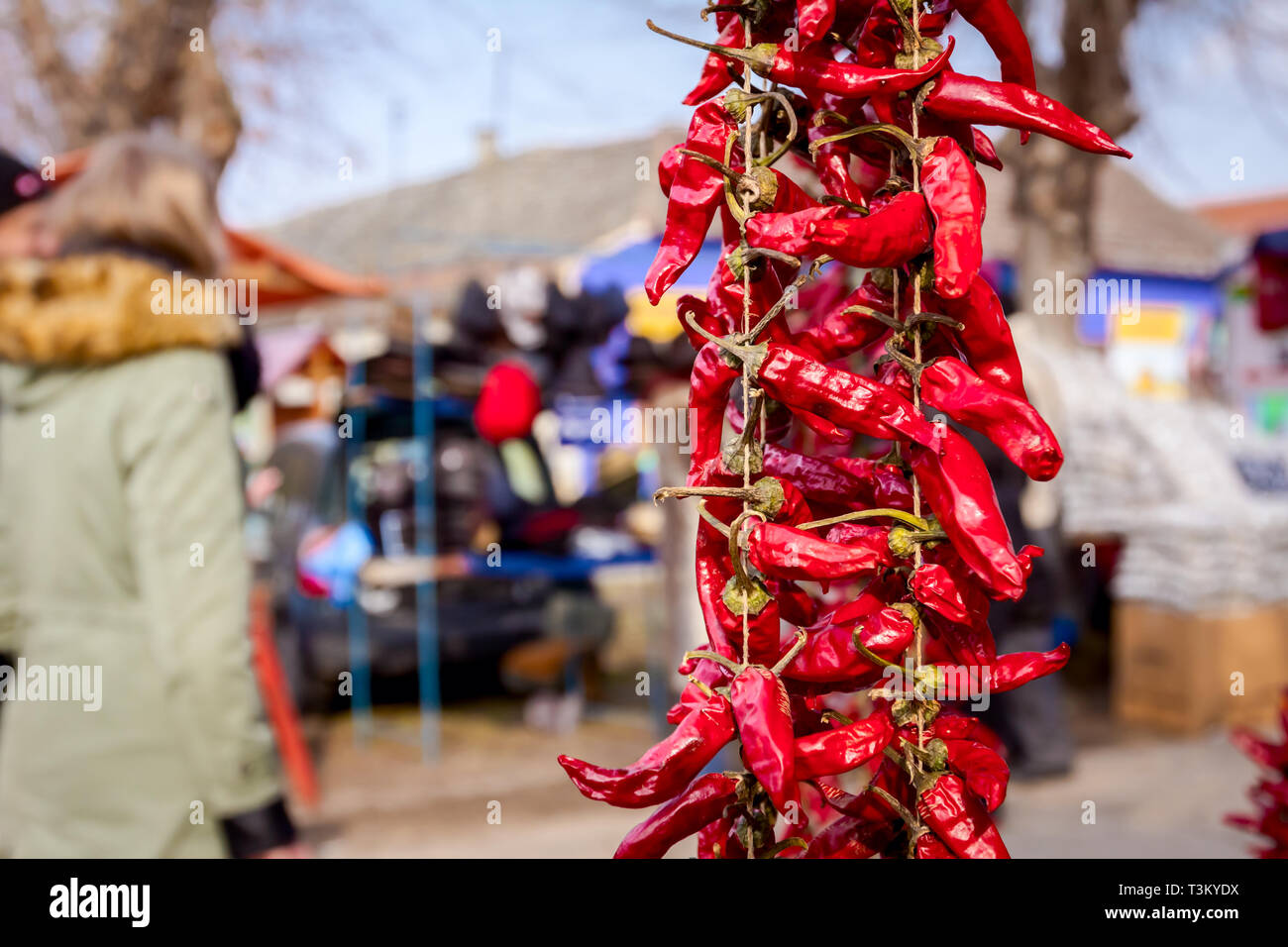 Bunch of decorated dried red hot peppers were placed at outdoor market ...