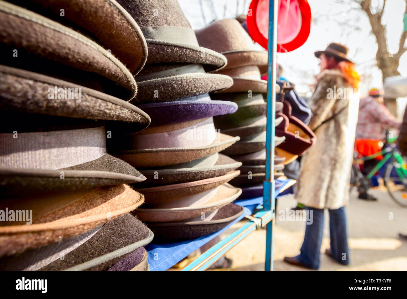 Stacked various colored men hats for sale, available at flea market
