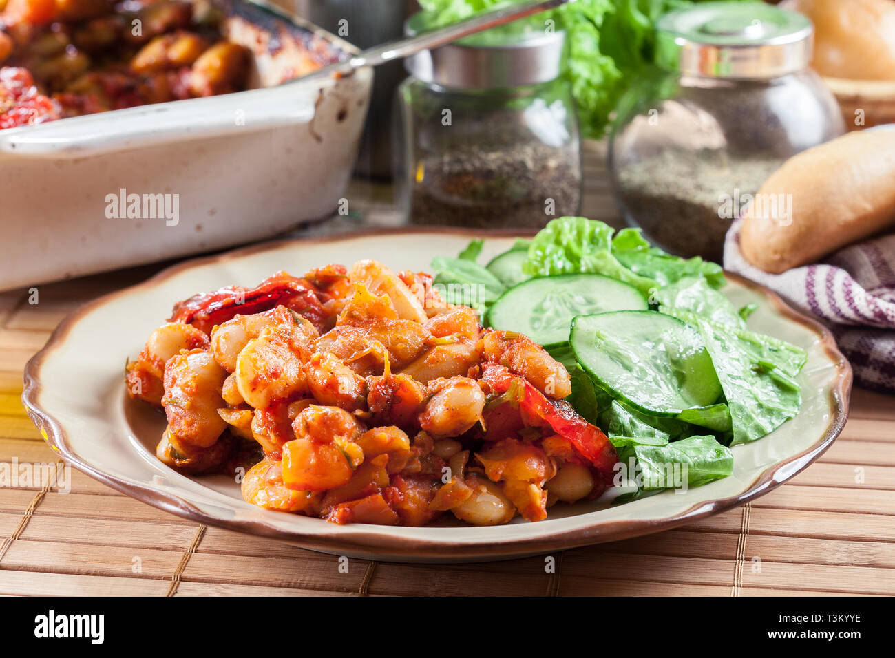 Baked giant beans with tomato sauce. Greek traditional food Stock Photo