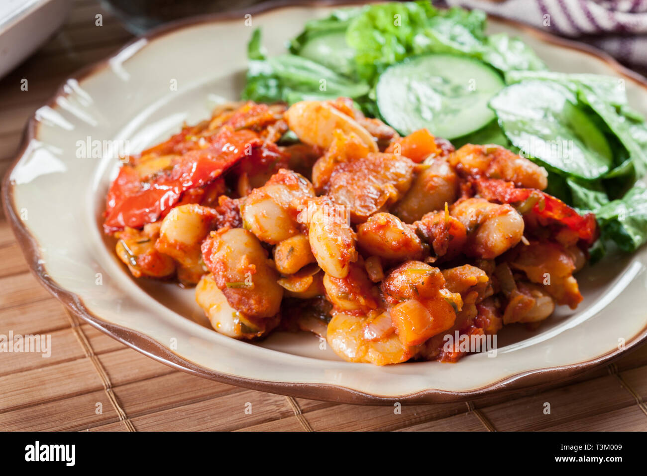 Baked giant beans with tomato sauce. Greek traditional food Stock Photo