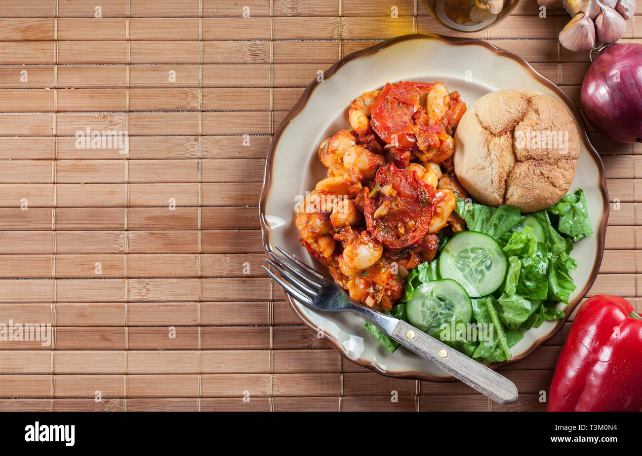 Baked giant beans with tomato sauce. Greek traditional food Stock Photo