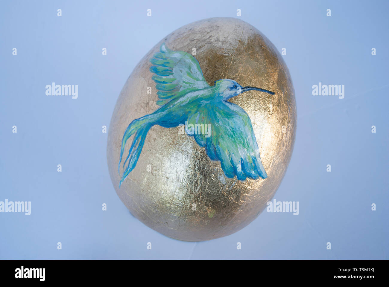 Golden Easter egg with the bird painted Stock Photo