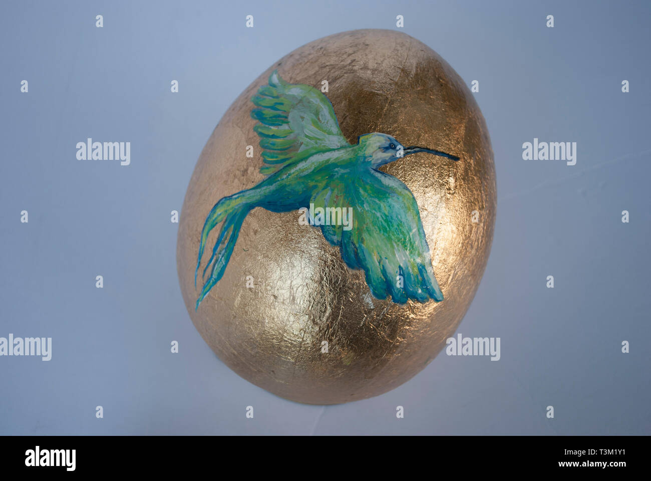 Golden Easter egg with the bird painted Stock Photo