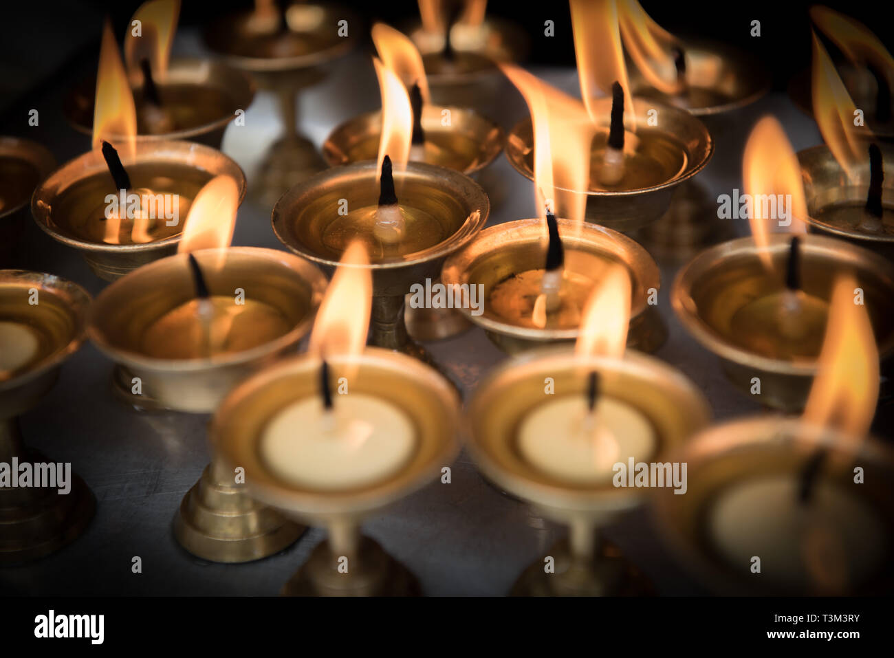 Lit prayer candles at the Ganesh shrine, Ason Tol, Kathmandu, Nepal Stock Photo