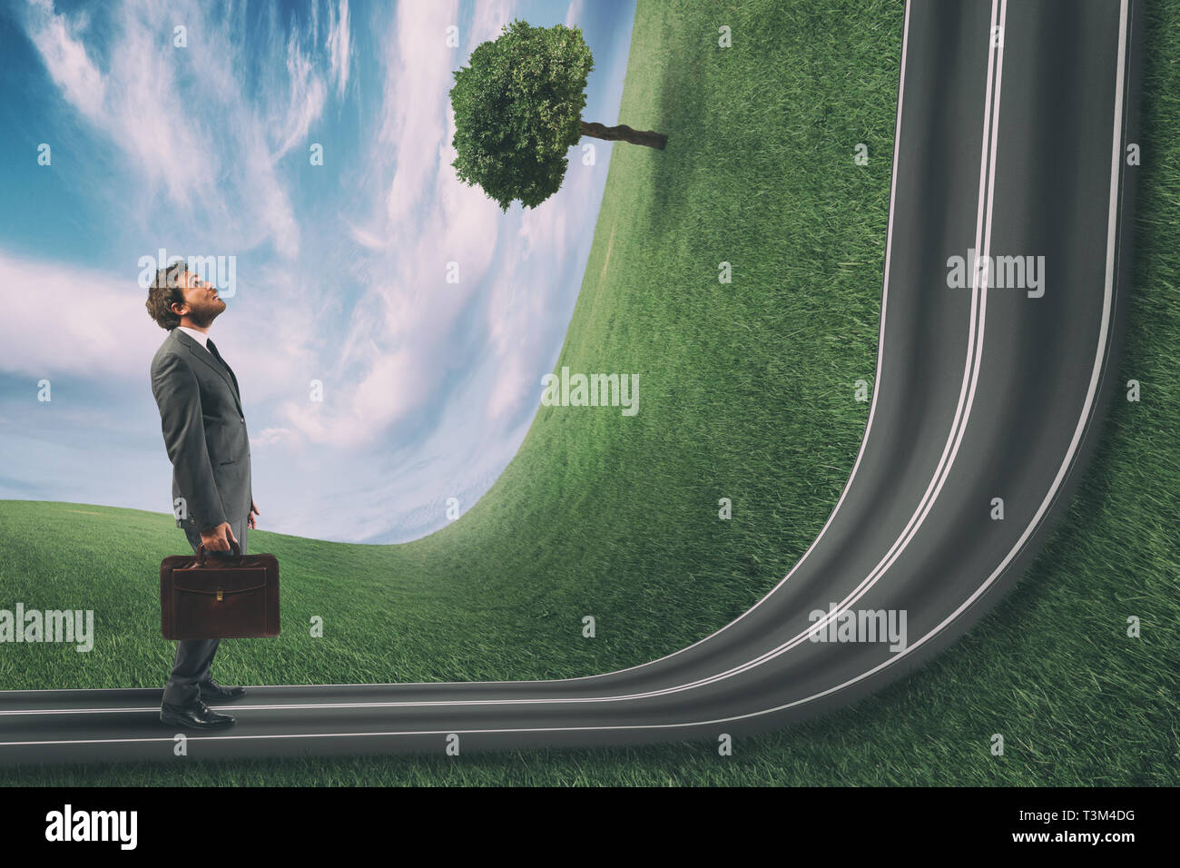 Businessman observes the road uphill in front of him. Achievement business goal and difficult career concept Stock Photo