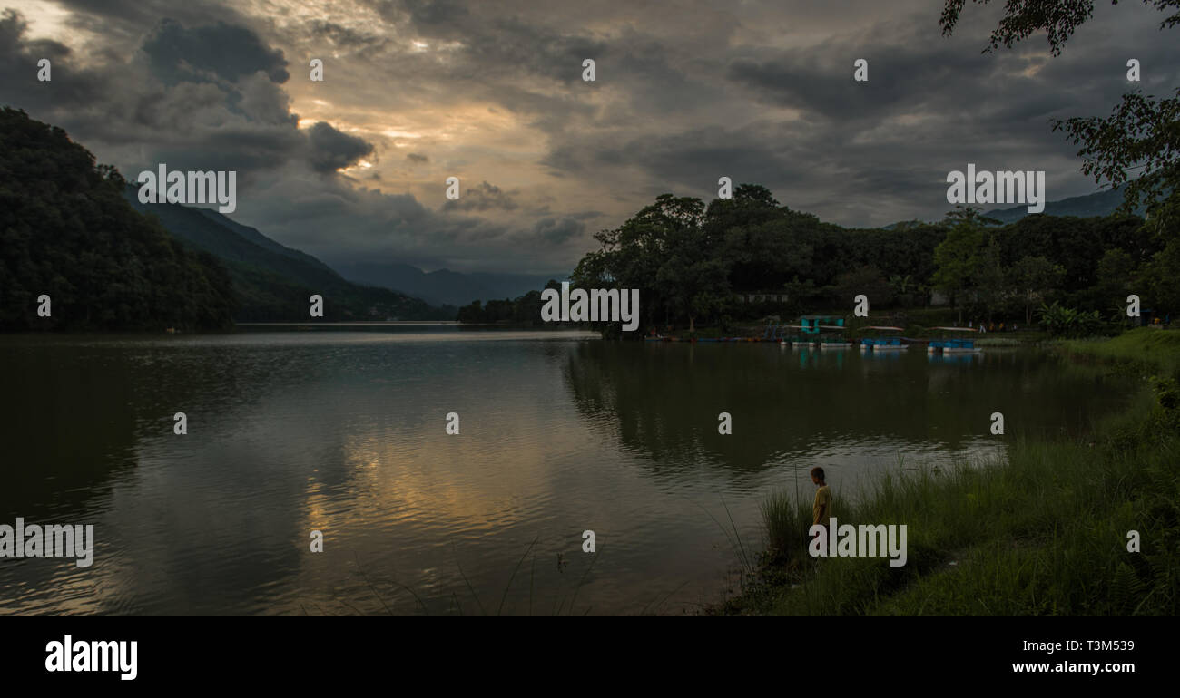 Reflections on Phewa lake after sunset, Pokhara, Nepa Stock Photo