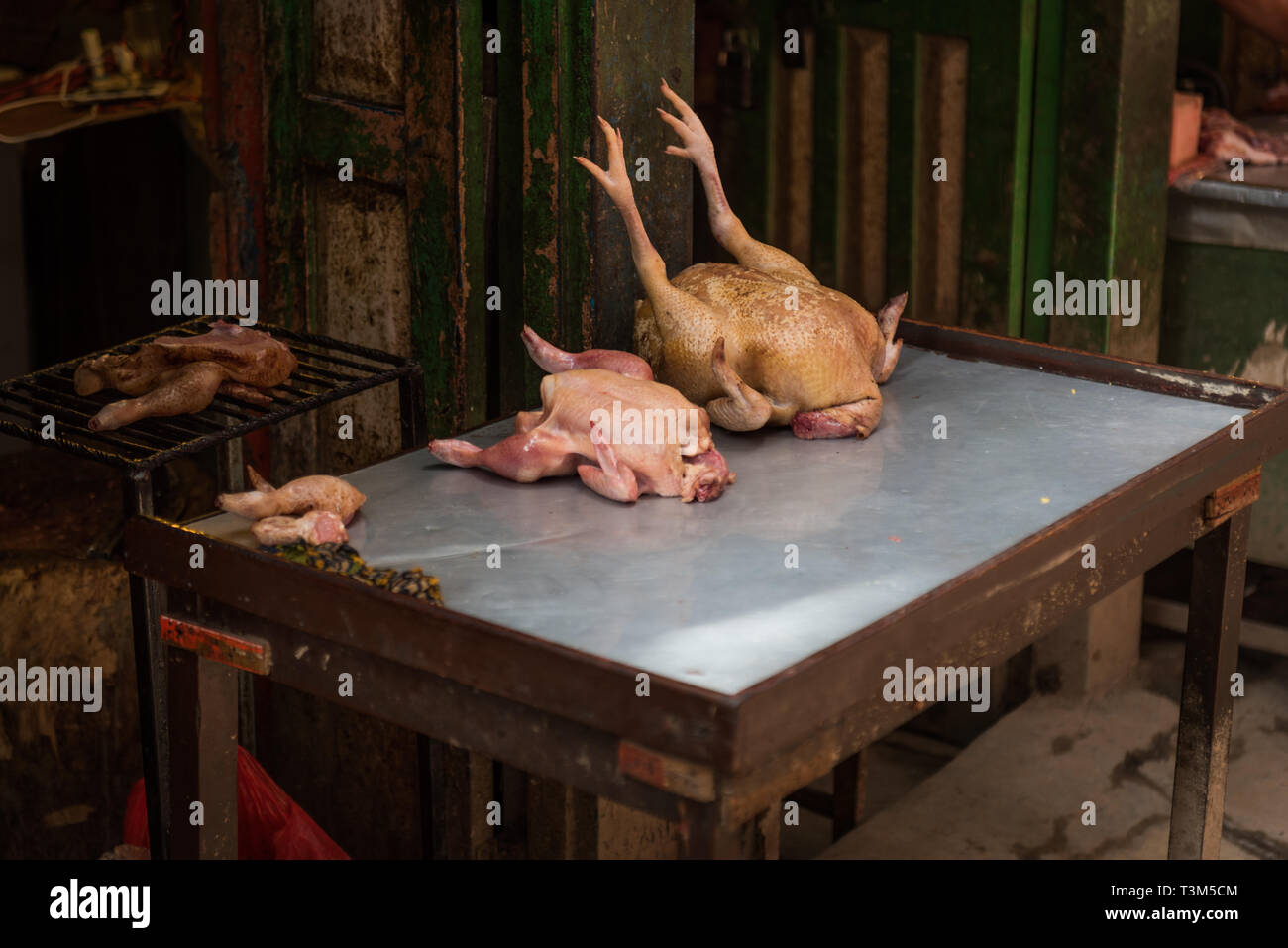 Two dead chickens resting on a metal table at a butchers, Ason Tol, Kathmandu, Nepal Stock Photo