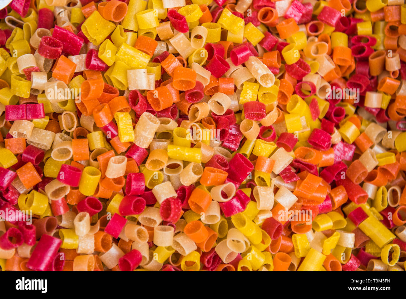 Red, orange and yellow dried pasta at Bhaktapur market, Nepal Stock Photo