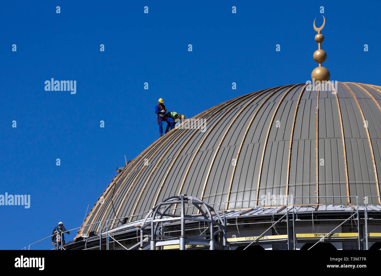Taksim, Istanbul / Turkey - March 18th, 2019: The mosque construction continues as technicians inspect the dome. Stock Photo