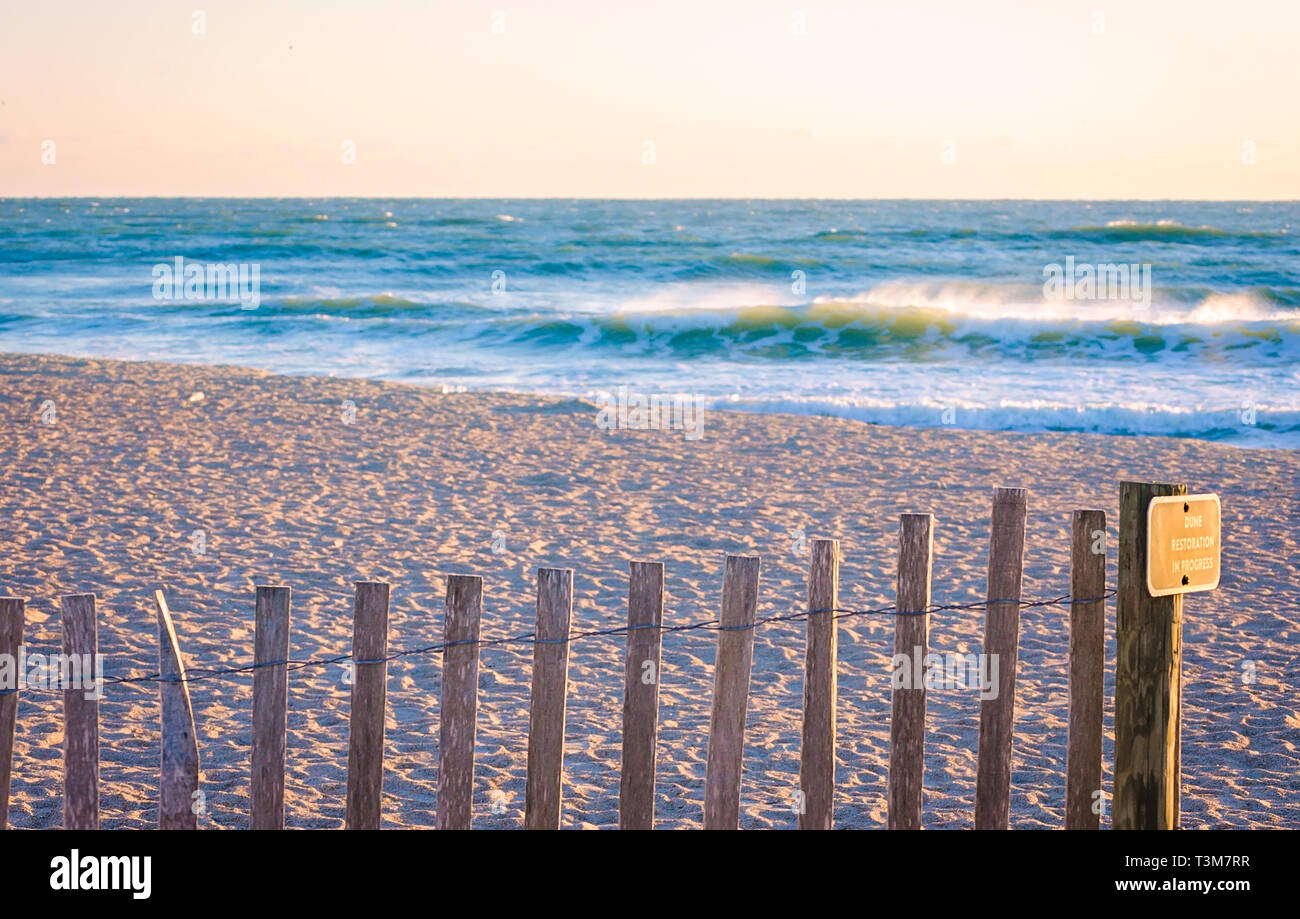 A wooden fence protects sand dunes undergoing restoration, March 21, 2016, in St. Augustine, Florida. Sand dunes protect the beach from erosion. Stock Photo