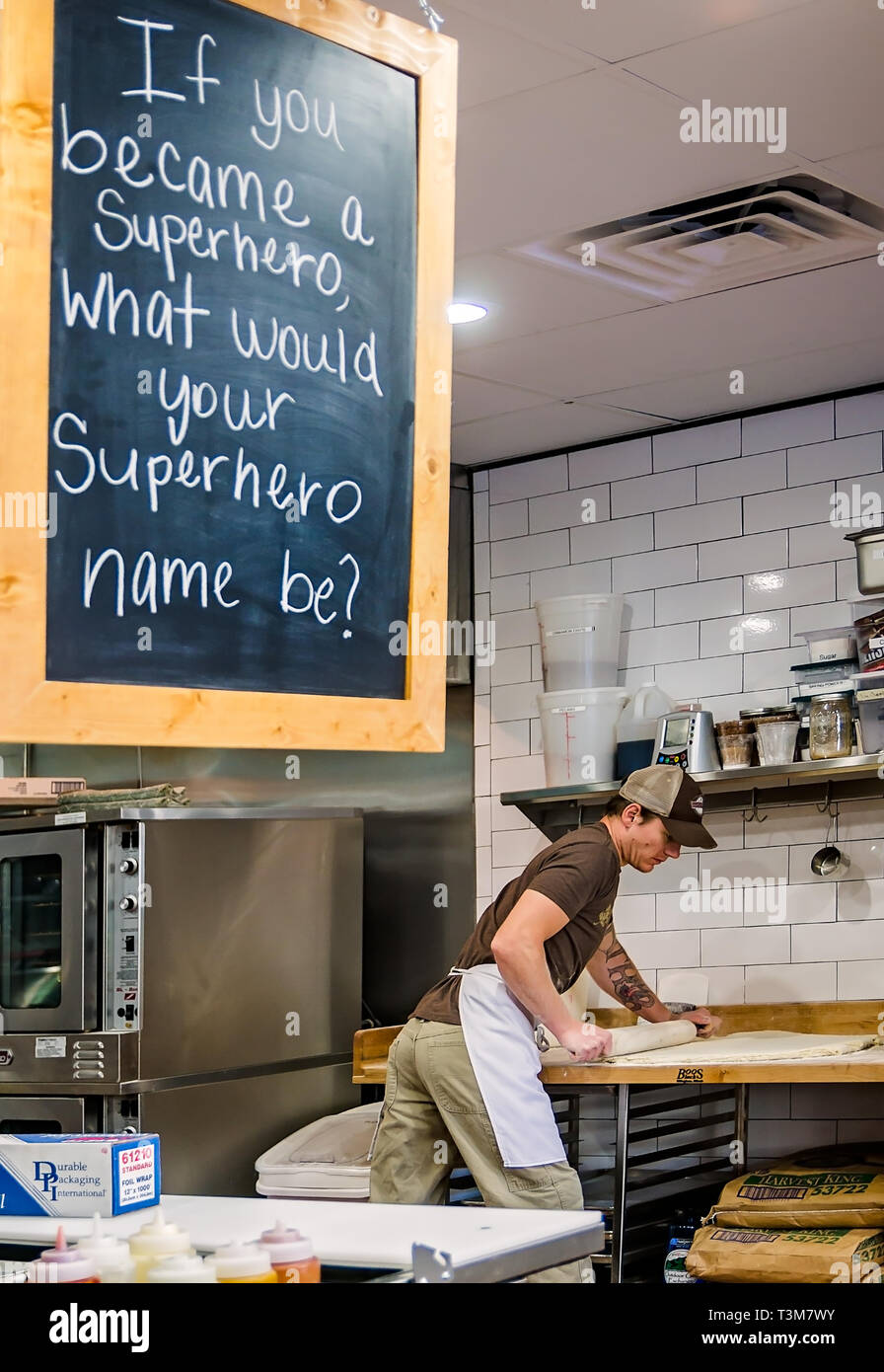 An employee rolls out biscuit dough at Maple Street Biscuit Company, March 21, 2016, in St. Augustine, Florida. Stock Photo