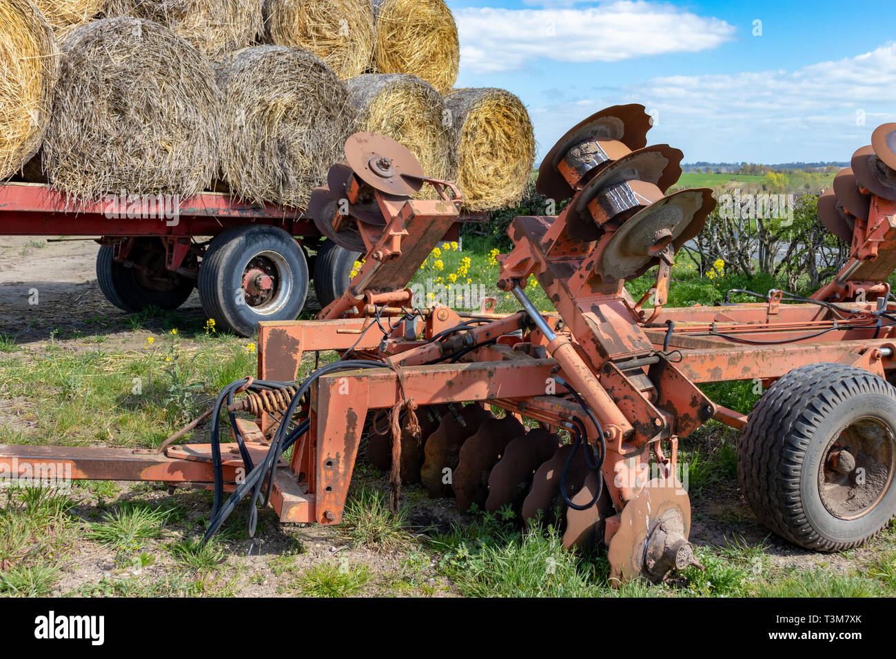 Straw Rolls Hay  Bales Loaded on a Trailer ready for Winter Feed plus a Mobile Plough in Derbyshire UK Stock Photo