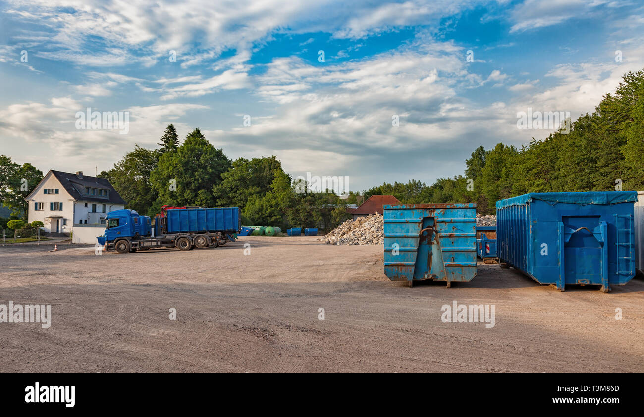 Recycling yard with trucks and different containers Stock Photo