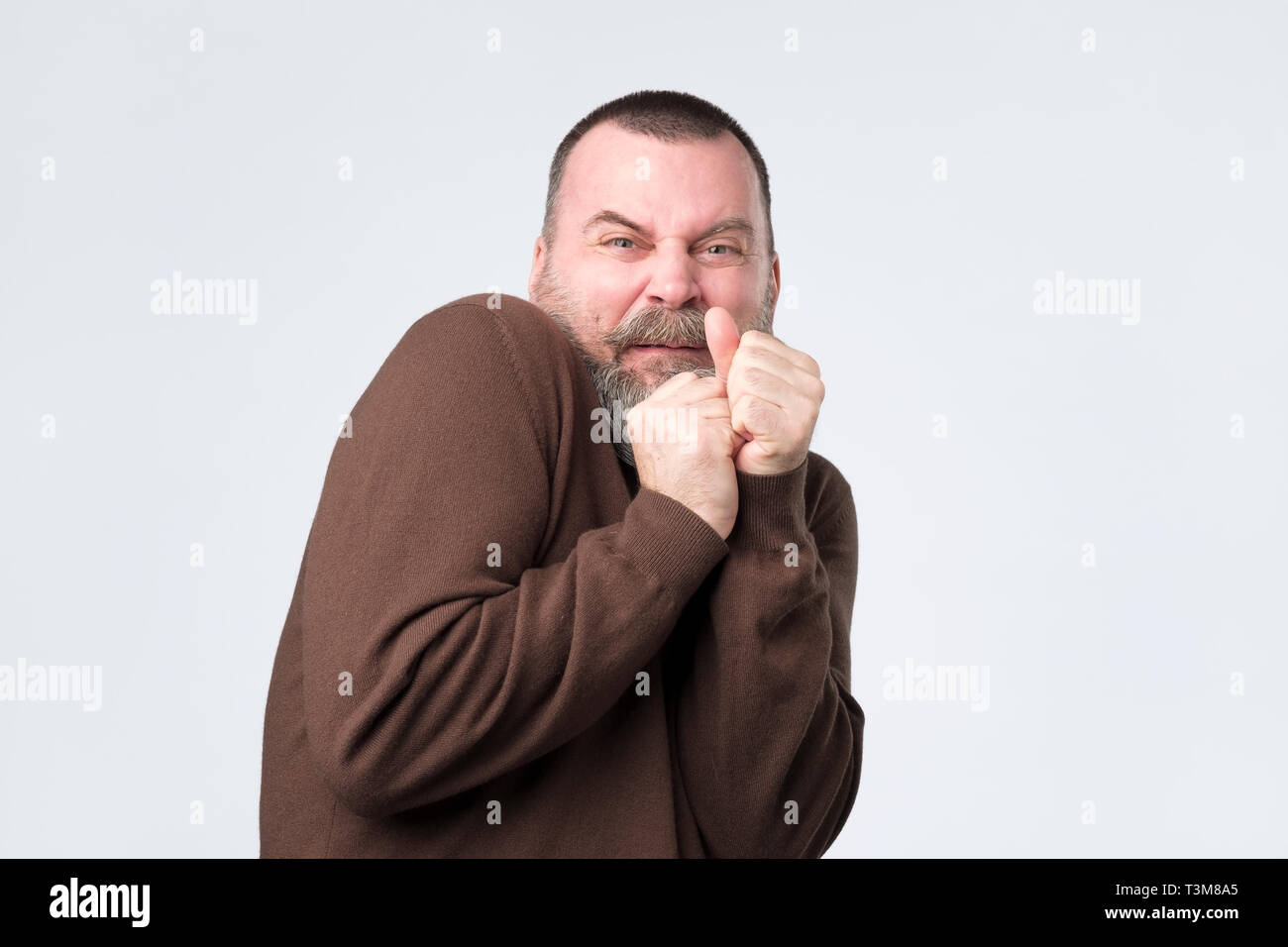 Frightened mature man with expression of fear on face. Stock Photo