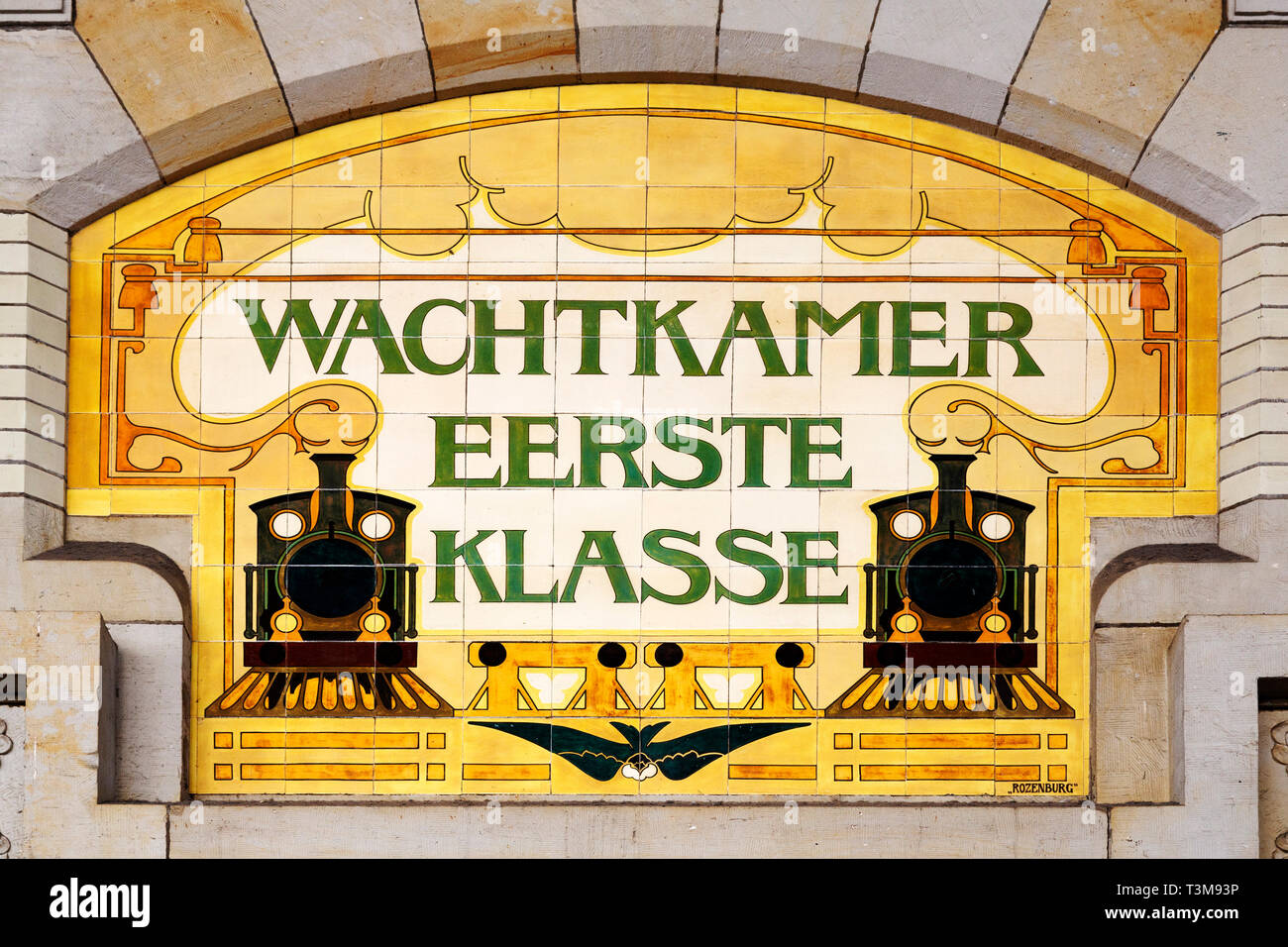 A tile sign for the first class waiting room at the railway station in Haarlem, the Netherlands. Steam locomotives are depicted on the sign. Stock Photo