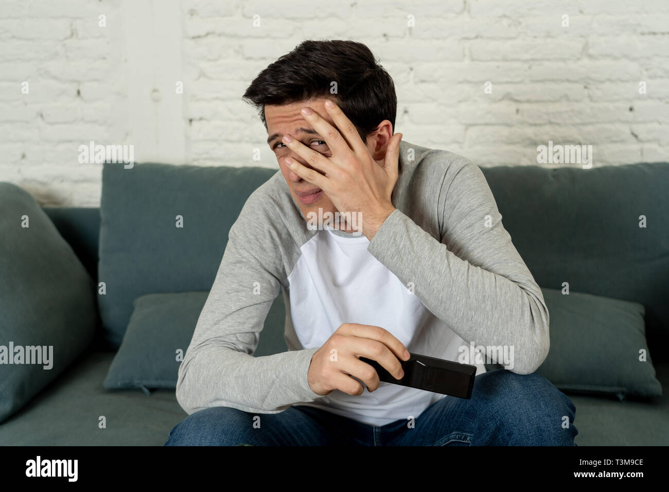 Lifestyle portrait of young man feeling scared and shocked making fear