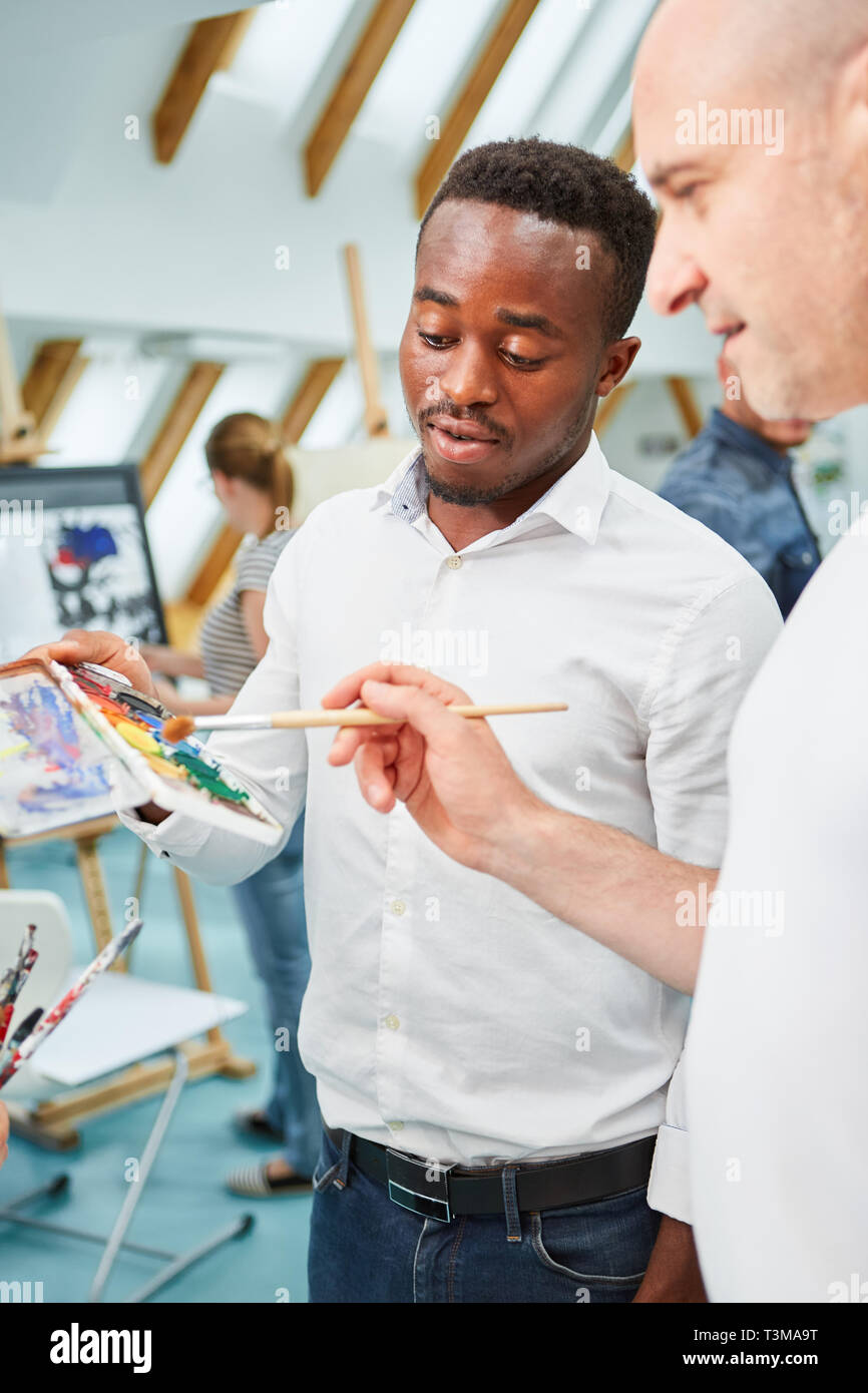 Art students in a creative beginner painting class or workshop learning painting Stock Photo