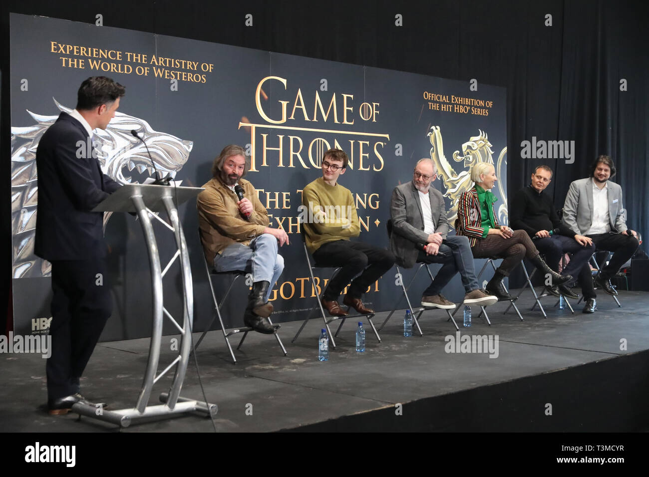 Left to right; host Graham Little, actors Ian Beattie, Isaac Hempstead Wright and Liam Cunningham, costume designer Michele Clapton, Robin Stapley of GES Events and Jeff Peters, HBO's vice president for licensing and retail at the launch of the Game of Thrones touring exhibition at the Titanic Exhibition Centre in Belfast. Stock Photo
