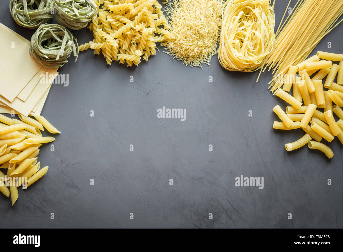 Different types of pasta from durum wheat varieties for cooking Mediterranean dishes. Top view, space for text. Stock Photo