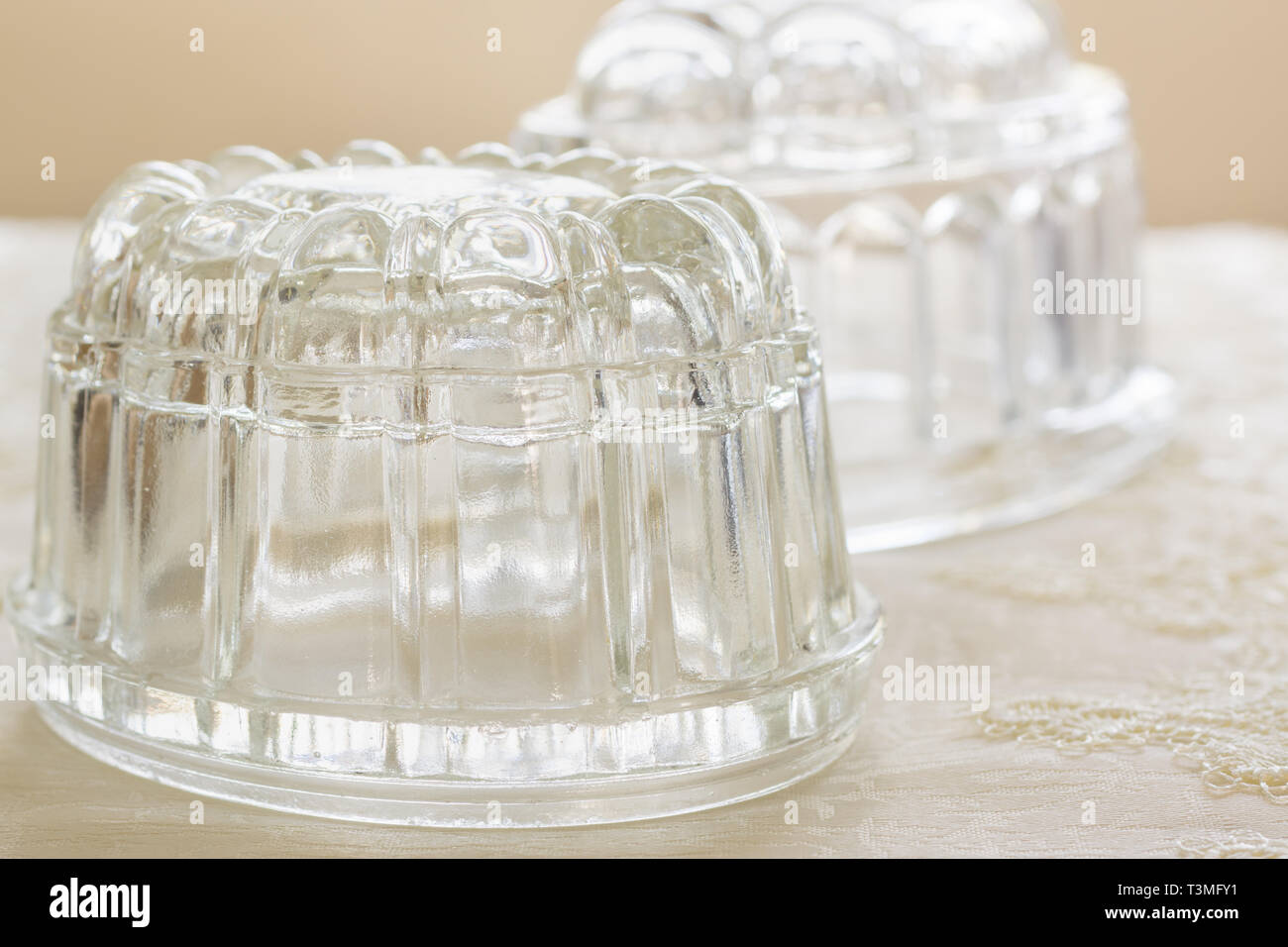 Old fashioned glass jelly or blancmange moulds for making traditional jellies Stock Photo