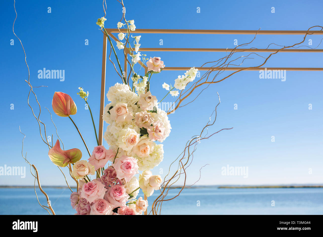 Part Of The Wedding Arch Decorated With Fresh Flowers Is Set On The