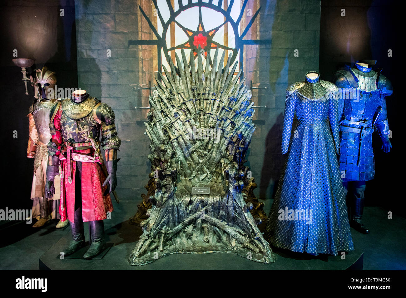 Lef to right; armour worn by Meryn Trant, played by Ian Beattie, a costume worn by Joffrey Baratheon, played by Jack Gleeson, a leather dress worn by Cersei Lannister, played by Lena Headey, and the armour worn by Gregor ???The Mountain??? Clegane, played by Conan Stevens, on display in The Great Hall at the launch of the Game of Thrones touring exhibition at the Titanic Exhibition Centre in Belfast. Stock Photo