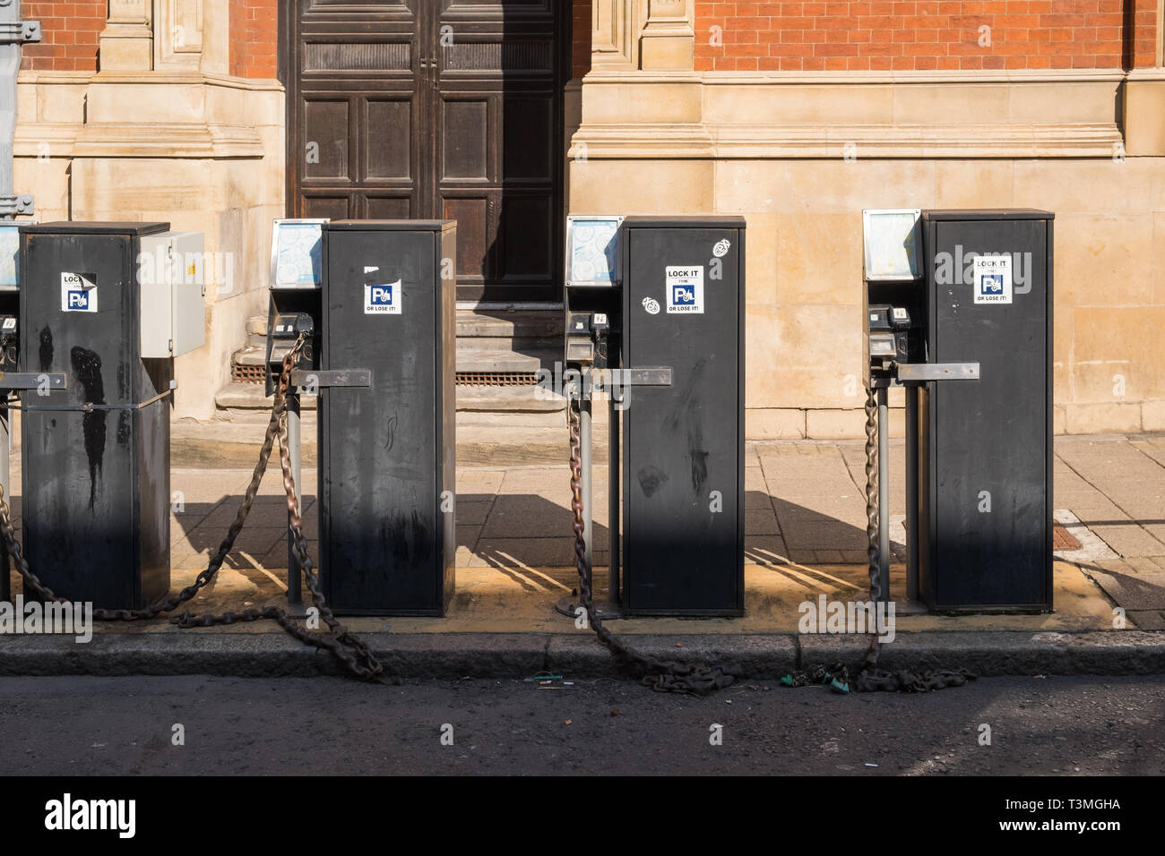 Row of locking motorbike roadside security docking stations in Leicester city centre Stock Photo