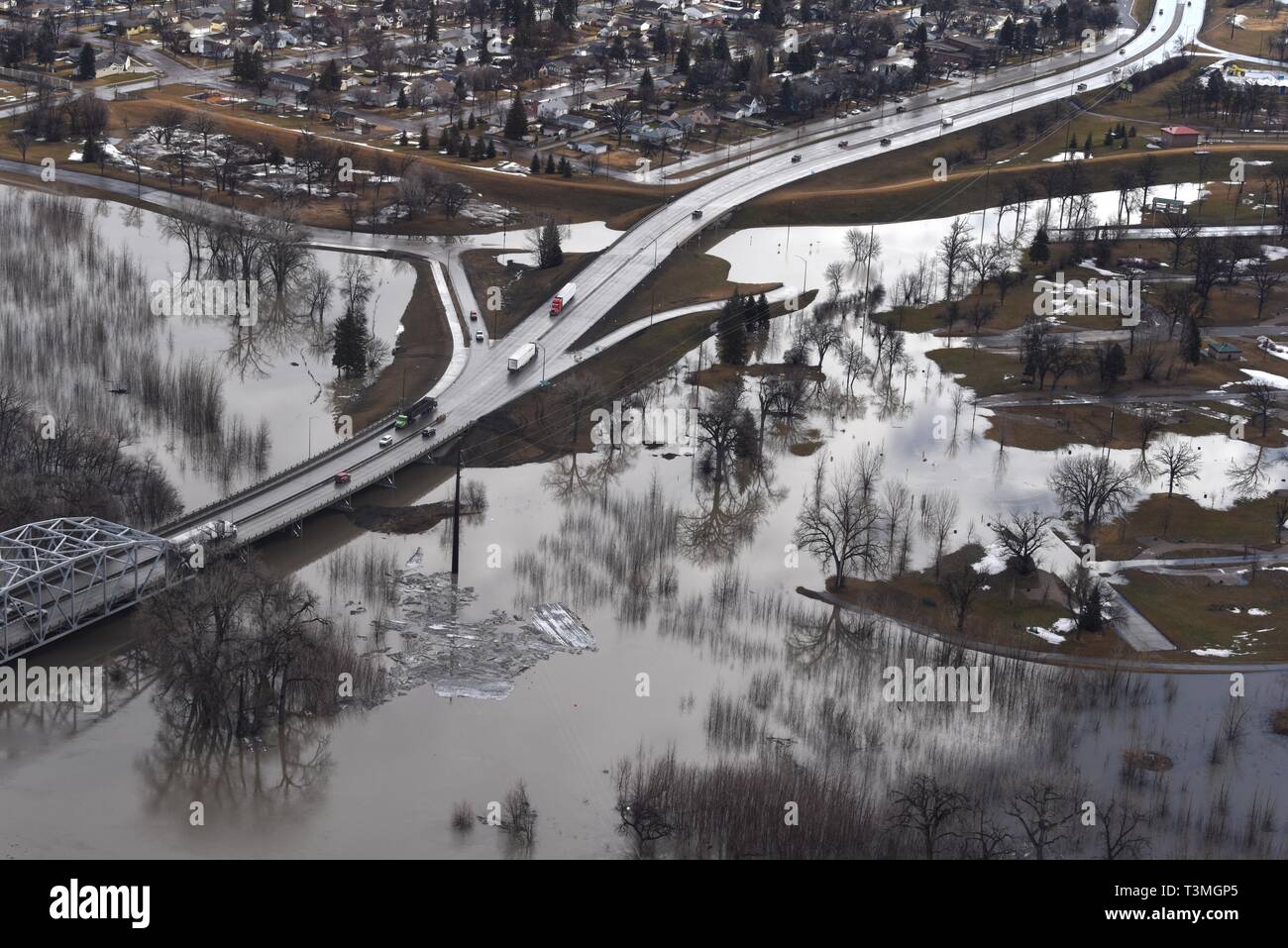 Aerial view of spring floods along the Red River and Red Lake River by the Sorlie Bridge April 8, 2019 in Grand Forks, North Dakota. The record flooding is expected to worsen as a late winter storm barrels into the midwestern United States over the next few days. Stock Photo