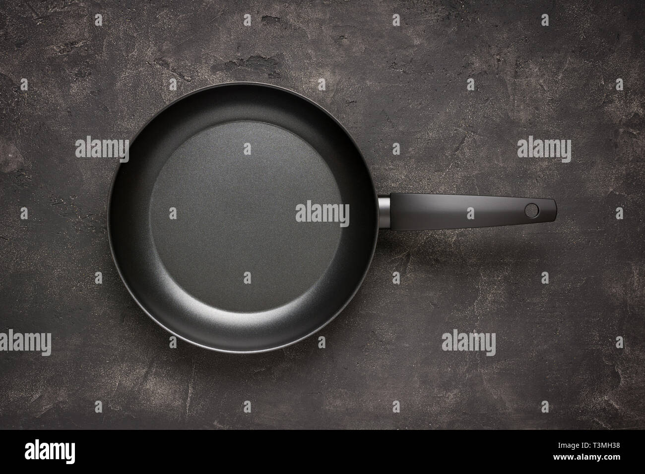 Empty Frying Pan Black on Dark Stone Surface. Culinary Background. Stock Photo