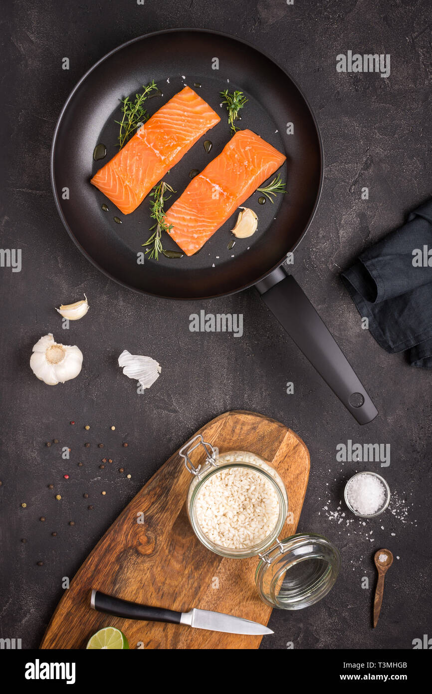 Salmon Steaks Fresh and Raw in Frying Pan with Thyme and Garlic Stock Photo