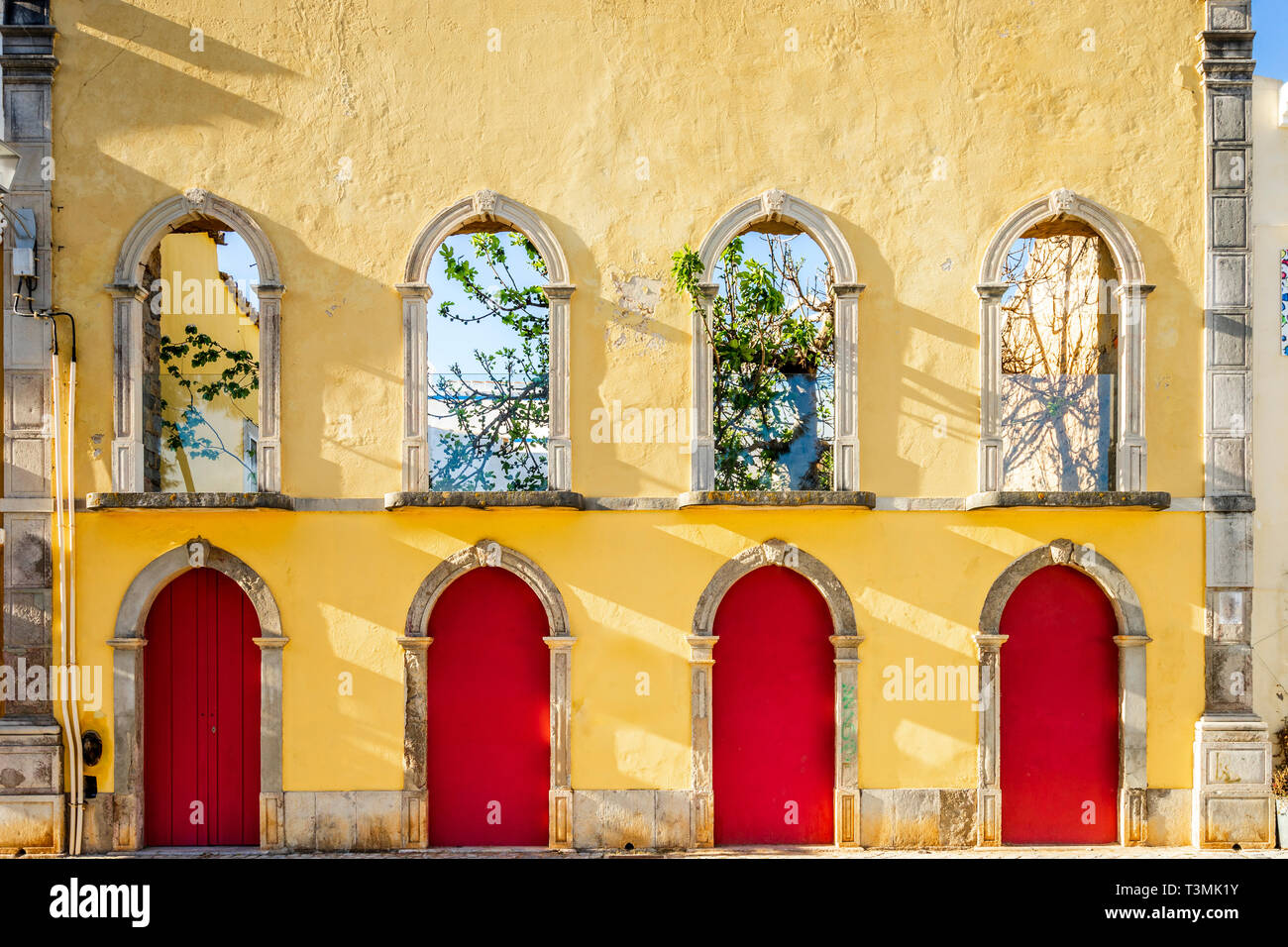 Yellow façade of empty traditional house in Tavira, Algarve, Portugal Stock Photo