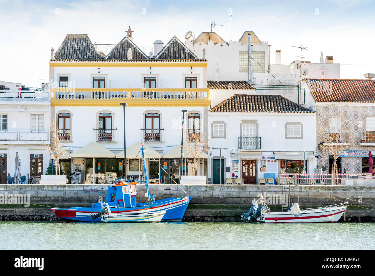 Charming architecture of Tavira with boats on Gilao river, Algarve, Portugal Stock Photo