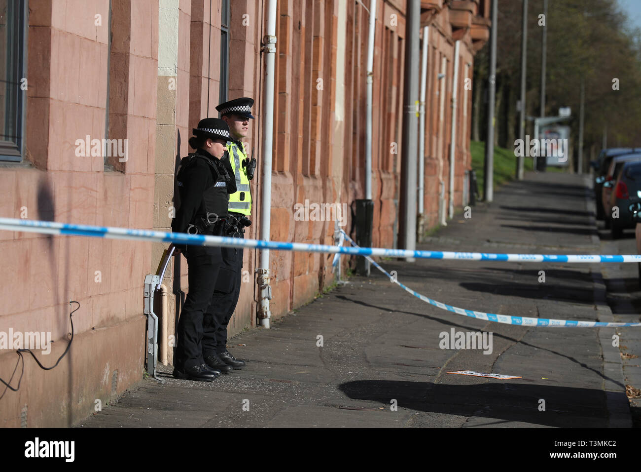 Police outside a block of flats on Dumbarton Road, close to Boquhanran