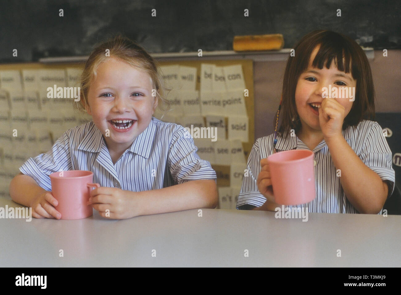 Two girls laughing classroom hi-res stock photography and images - Alamy