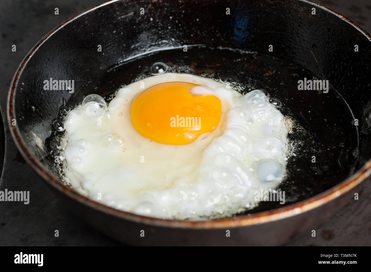 Fried egg in frying pan Stock Photo
