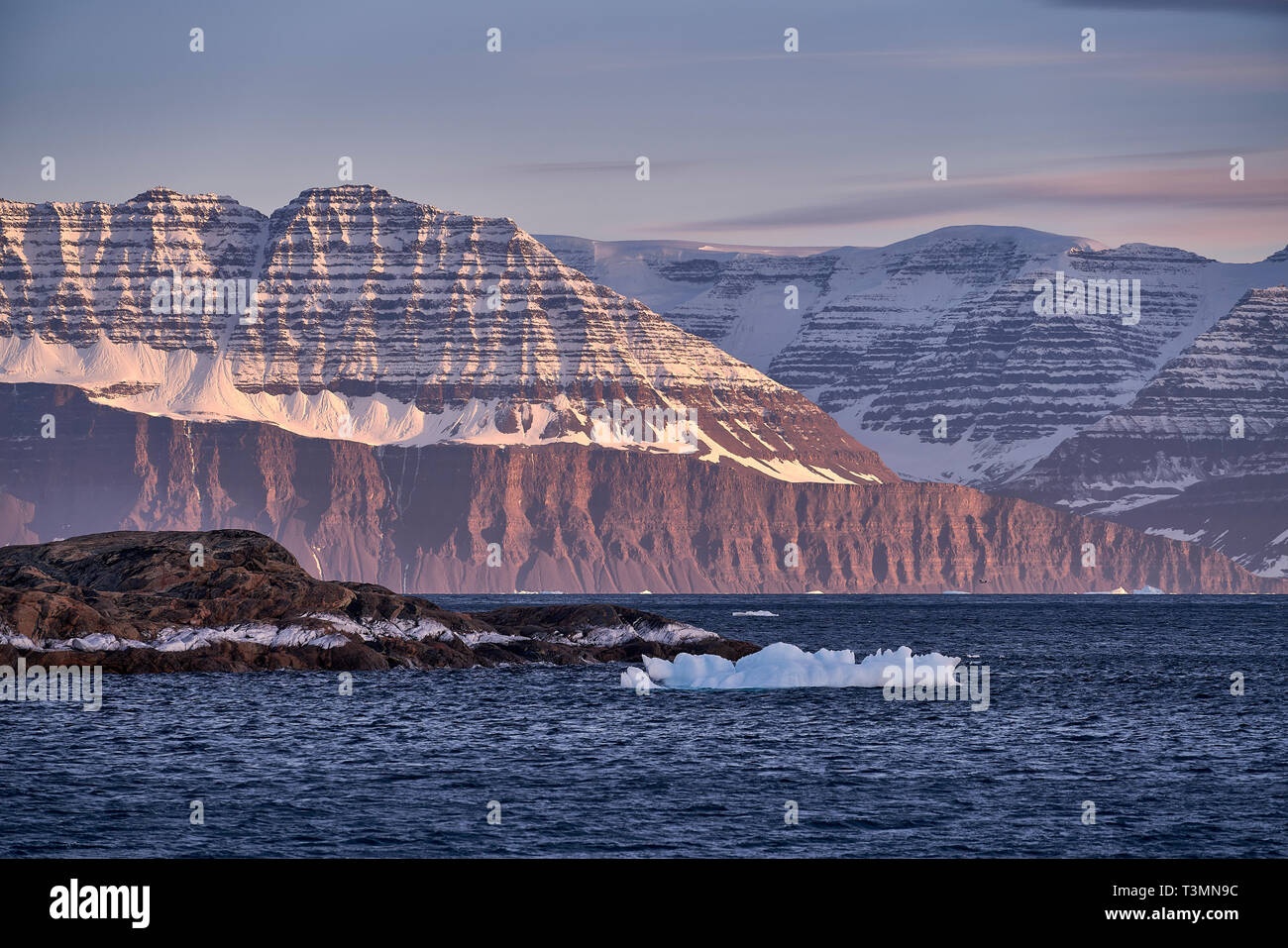 Icebergs at sunset, Scoresbysund, Greenland Stock Photo