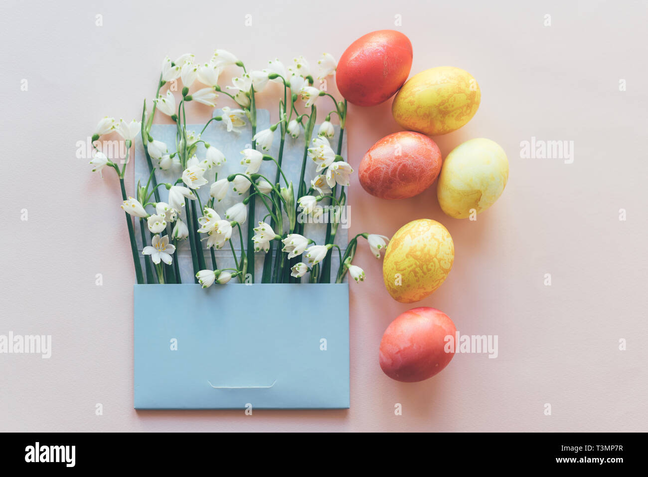 set of colored eggs and flowers in the envelope Stock Photo